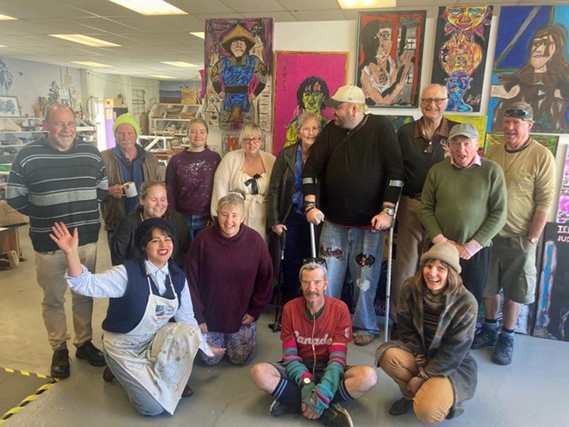 A group of artists pose for a photo at Magenta